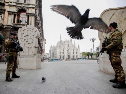 Italian soldiers patrol as the Duomo gothic cathedral is visible in background, in Milan, Friday, March 20, 2020. Mayors of many towns in Italy are asking for ever more stringent measures on citizens' movements to help contain the surging infections of the coronavirus. For most people, the new coronavirus causes …