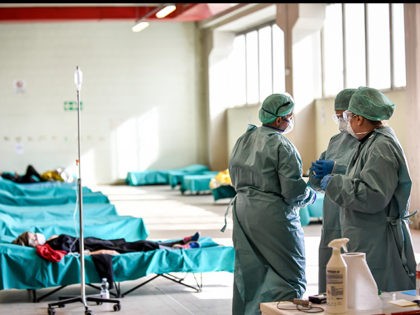 Medical personnel work inside one of the emergency structures that were set up to ease pro