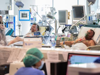 Patients lie in bed inside the new coronavirus intensive care unit of the Brescia Poliambu