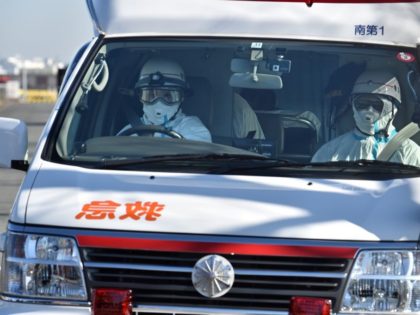 TOPSHOT - An ambulance departs the Japan Coast Guard base in Yokohama on February 5, 2020