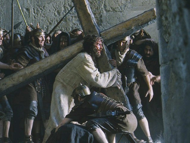 Actor Jim Caviezel portrays Jesus carrying the Cross in a scene from the new film "The Pas
