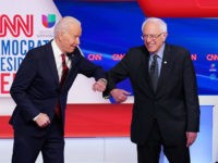 Democratic presidential hopefuls former US vice president Joe Biden (L) and Senator Bernie Sanders (R) greet each other with an elbow bump as they arrive for the 11th Democratic Party 2020 presidential debate in a CNN Washington Bureau studio in Washington, DC on March 15, 2020. (Photo by MANDEL NGAN …
