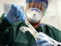 Nurse Canan Emcan shows a test kit for coronavirus samples at the isolation ward of the Uniklinikum Essen university hospital in Essen, western Germany, on March 9, 2020. - The number of coronavirus cases in Germany has passed 1,000, official data from the Robert Koch Institute disease control centre showed. …