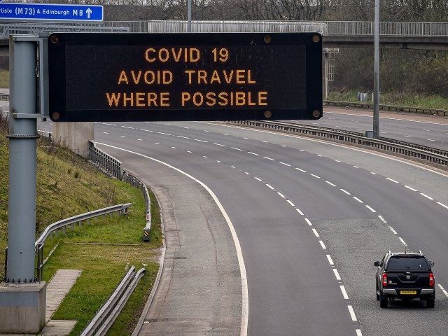 GLASGOW, SCOTLAND - MARCH 24: A sign on the M8 motorway advises motorists to avoid travel where possible on March 24, 2020 in Glasgow, Scotland. First Minister of Scotland Nicola Sturgeon along with British Prime Minister, Boris Johnson, announced strict lockdown measures last night urging people to stay at home …