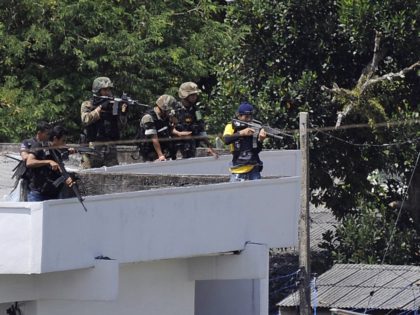 Thai snipers aim rifles to control a situation during a prison riot in Narathiwat province on August 11, 2011. Inmates rioted at the Narathiwat provincial prison during a search for illicit drugs, at least two people were injured. AFP PHOTO / MADAREE TOHLALA (Photo credit should read MADAREE TOHLALA/AFP via …
