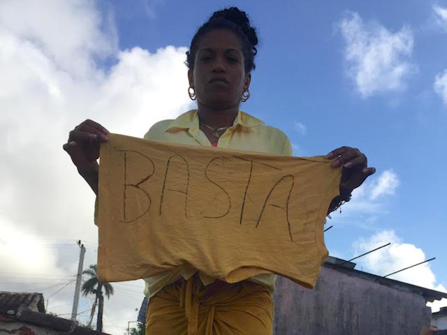 Cuban protester holds up sign reading "enough," protesting Cuba refusing to impose social distancing and encouraging tourism during the Chinese coronavirus pandemic. March 19, 2020.