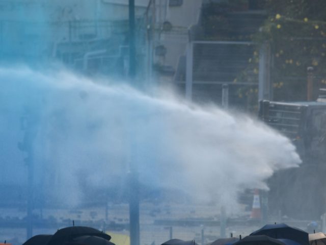 Police use water cannon outside the Hong Kong Polytechnic University to disperse protesters in Hong Kong on November 17, 2019. - Hong Kong police clashed with pro-democracy activists who vowed to "squeeze the economy" as the increasingly divided city reels from one of the worst weeks of violence in the …