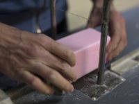 In this photo taken Monday March 16 2020, a factory worker cuts soap into bars at the Licorne soap factory in Marseille, southern France. Amid the rapid outbreak of the new coronavirus across Europe, the hallmark Marseille tradition of soap-making is enjoying a renaissance, as the French public rediscovers this …