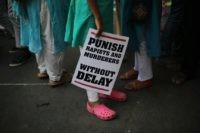 In this April 15, 2018, file photo, an Indian protester stands with a placard during a protest against two recently reported rape cases as they gather near the Indian parliament in New Delhi, India. Four men sentenced for capital punishment for the 2012 gang-rape of a 23-year-old physiotherapy student on &hellip;