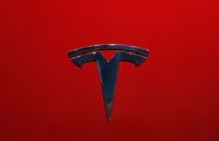 This Oct. 3, 2018, file photo shows the logo of Tesla Model 3 at the Auto show in Paris. The National Transportation Safety Board says two drivers, Tesla and lax regulation of new partially automated driving systems are to blame for a fatal 2019 crash in Florida involving a Tesla &hellip;