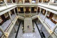 Travis Swann Taylor walks through a nearly empty Georgia State Capitol on Thursday, March 19, 2020, after Georgia lawmakers were urged Wednesday to self-isolate themselves, after a state senator said he tested positive for the coronavirus. (Steve SchaeferAtlanta Journal-Constitution via AP)