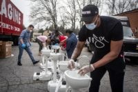 Grammy award-winning hip hop recording artist Lecrae assembles a portable wash station on Thursday, March 19, 2020 in College Park, Georgia. The wash stations were distributed by Lecrae and volunteers with Love Beyond Walls, a non-profit, throughout Atlanta in areas with a high density of homeless persons. (AP Photo/ Ron &hellip;