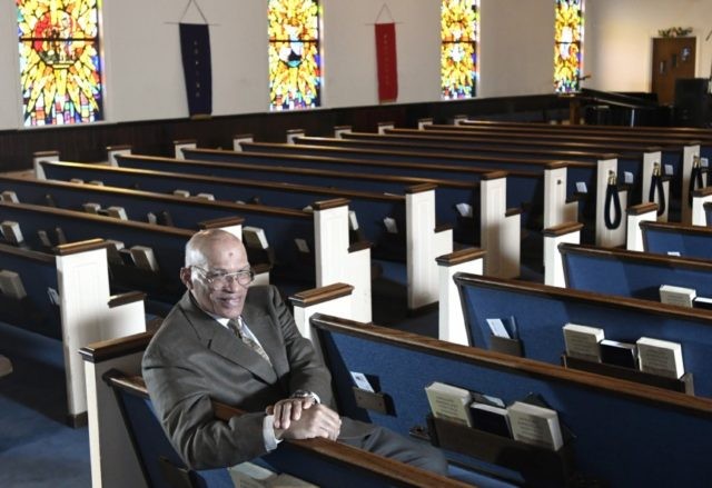 The Rev. Alvin J. Gwynn Sr., of Friendship Baptist Church in Baltimore, sits in his church's sanctuary, Thursday, March 19, 2020. He bucked the cancellation trend by holding services the previous Sunday. But attendance was down by about 50%, and Gwynn said the day’s offering netted about $5,000 compared to …