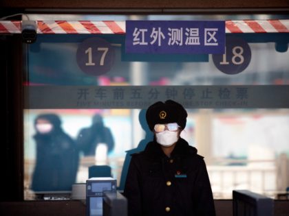 A station worker wears a face mask and goggles as she waits to check passengers' tickets at the Beijing Railway Station in Beijing, Saturday, Feb. 15, 2020. People returning to Beijing will now have to isolate themselves either at home or in a concentrated area for medical observation, said a …