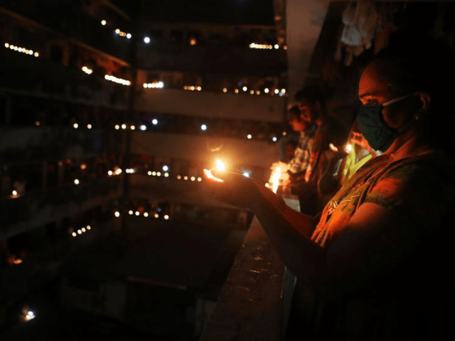 People light lamps to mark the country’s fight against the Covid-19 pandemic in Mumbai. (Image: AP)