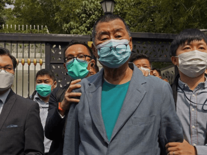 Hong Kong media tycoon Jimmy Lai, center, who founded local newspaper Apple Daily, is arrested by police officers at his home in Hong Kong, Saturday, April 18, 2020. Hong Kong police arrested at least 14 pro-democracy lawmakers and activists on Saturday on charges of joining unlawful protests last year calling …