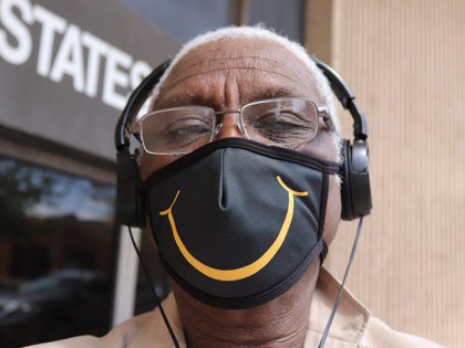 Elvert Barnes wearing FLATTEN THE CURE BALTIMORE Face Mask by SEW LAB USA in front of US P