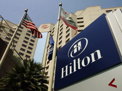 Flags fly outside the Hilton Hotel in Long Beach, Calif., Tuesday, July 31, 2007. Hilton Hotels Corp. reported strong earnings growth Tuesday in the second quarter as it prepared to be acquired by the Blackstone Group. The worldwide hotel and resort company reported net income of $165 million, or 40 …