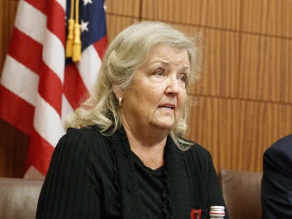 Republican presidential candidate Donald Trump looks on as Juanita Broaddrick, who has accused former President Bill Clinton of sexual assault, speaks before the second presidential debate against democratic presidential candidate Hillary Clinton, Sunday, Oct. 9, 2016, in St. Louis. (AP Photo/ Evan Vucci)