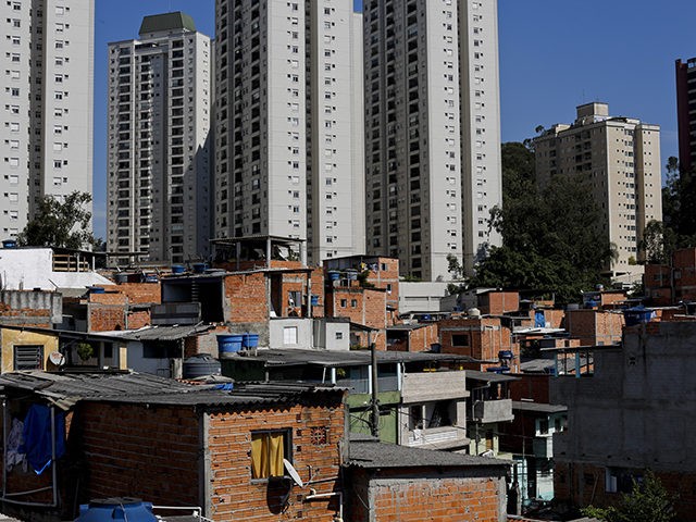 This May 22, 2019 photo shows brick and block brick houses of the sprawling slum neighborhood of Paraisopolis stacked next to the posh Morumbi neighborhood, in Sao Paulo, Brazil. A study released this month by the Getulio Vargas Foundation found that the key measure of income inequality has reached its …