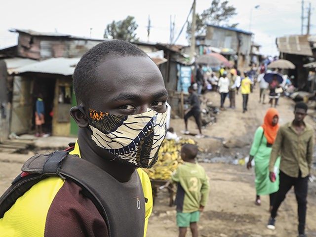 A boda-boda, or motorcycle taxi, driver wears a makeshift mask made from a local fabric kn