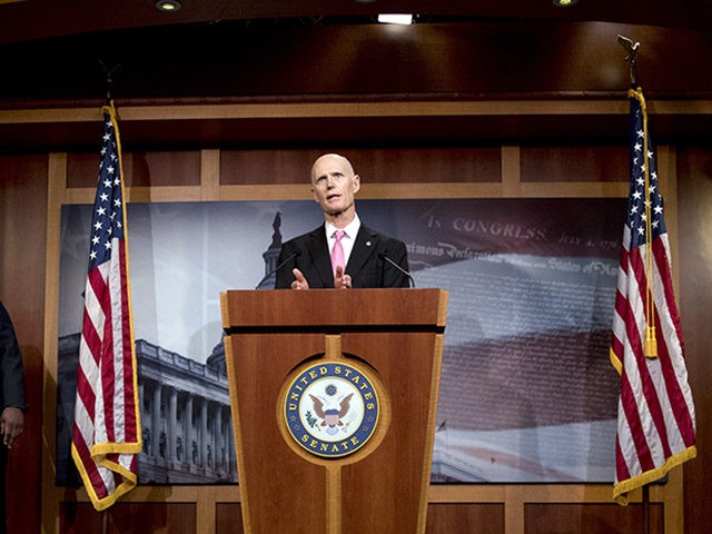 Sen. Rick Scott, R-Fla., left, accompanied by Sen. Ben Sasse, R-Neb., left, Sen. Tim Scott, R-S.C., second from left, and Sen. Lindsey Graham, R-S.C., right, speaks at a news conference about the coronavirus relief bill on Capitol Hill in Washington, Wednesday, March 25, 2020. Senators discussed what they are calling …
