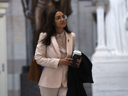 Rep. Alexandria Ocasio-Cortez, D-N.Y., walks Capitol Hill in Washington, Friday, March 27, 2020. (AP Photo/Susan Walsh)