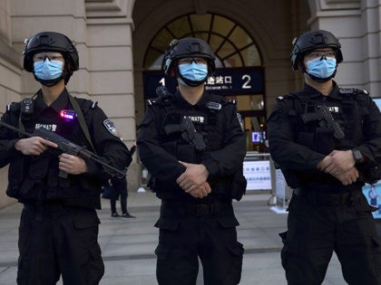 Police officers wearing face masks to protect against the spread of new coronavirus stand guard outside of Hankou train station ahead of the resumption of train services in Wuhan in central China's Hubei Province, Wednesday, April 8, 2020. After 11 weeks of lockdown, the first train departed Wednesday morning from …