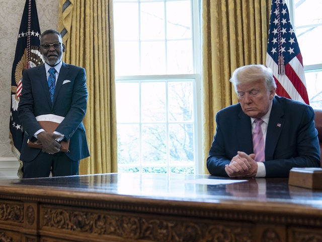 President Donald Trump prays during an Easter blessing event with Bishop Harry Jackson, in