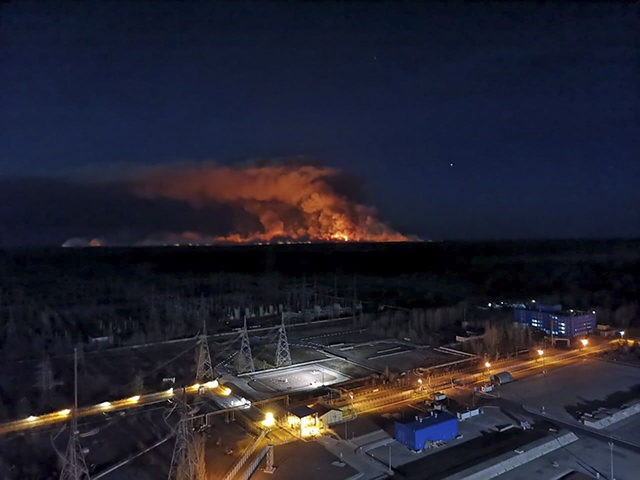 In this photo taken from the roof of Ukraine's Chernobyl nuclear power plant late Friday April 10, 2020, a forest fire is seen burning near the plant inside the exclusion zone. Ukrainian firefighters are labouring to put out two forest blazes in the area around the Chernobyl nuclear power station …