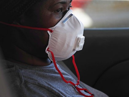A masked drive-up patient awaits a member of the Delta Health Center staff administering a free COVID-19 test in Mound Bayou, Miss., Thursday, April 16, 2020. The city is predominately African American and recent reports are that black Americans are dying of COVID-19 at disproportionately high rates in some areas. …