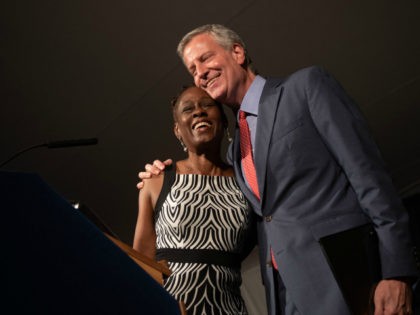 Bill de Blasio and wife, Chirlane McCray, hug at Gracie Mansion for the West Indian Heritage Reception.