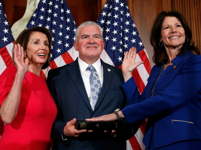 House Speaker Nancy Pelosi of Calif., left, poses during a ceremonial swearing-in with Rep. Cheri Bustos, D-Ill., right, on Capitol Hill, Thursday, Jan. 3, 2019 in Washington during the opening session of the 116th Congress. (AP Photo/Alex Brandon)