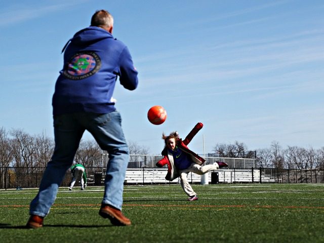 SEAFORD, NEW YORK, - MARCH 22: A Father and Daughter play soccer at Cedar Creek Park on Ma