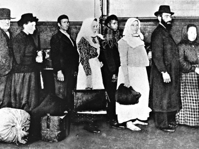 FILE - In this undated photo of a group of immigrants, who arrived at Ellis Island in New York, wait in line to begin immigration proceedings. Senior White House aide Stephen Miller told reporters Wednesday, Aug. 2, 2017, that the poem written by Emma Lazarus about the "huddled masses" is …