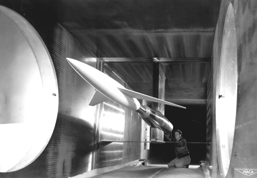 Testing advanced designs for high-speed aircraft, an engineer makes final calibrations to a model mounted in the 6 x 6 Foot Supersonic Wind Tunnel at the NACA Ames Aeronautical Laboratory, Moffett Field, California.