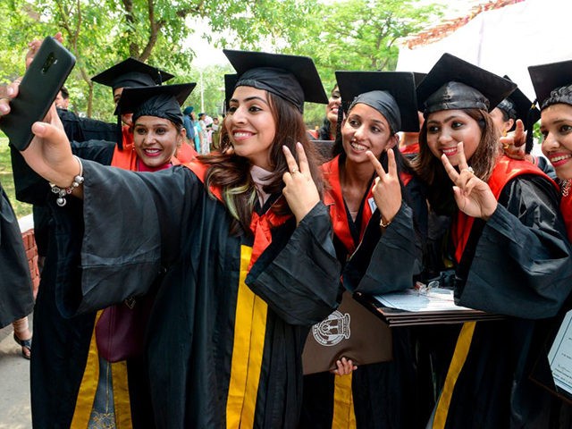Students take selfie after receiving their Doctor of Philosophy (PhD) degree during the Golden Jubilee Year Convocation at the Guru Nanak Dev University (GNDU) in Amritsar on July 19, 2019. (Photo by NARINDER NANU / AFP) (Photo credit should read NARINDER NANU/AFP via Getty Images)