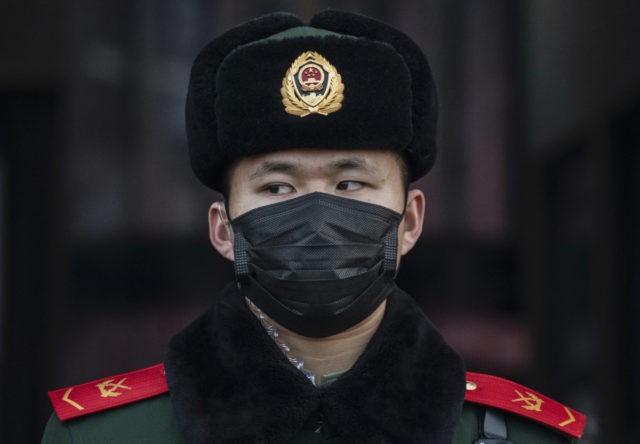 BEIJING, CHINA - JANUARY 22: A Chinese police officer wears a protective mask as he stands guard at Beijing Station before the annual Spring Festival on January 22, 2020 in Beijing, China. The number of cases of a deadly new coronavirus rose to over 400 in mainland China Wednesday as …