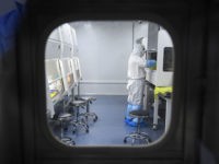 This photo taken on February 6, 2020 shows a laboratory technician working on samples from people to be tested for the new coronavirus at "Fire Eye" laboratory in Wuhan in China's central Hubei province. - BGI Group, a genome sequencing company based in southern China, said it opened on February …