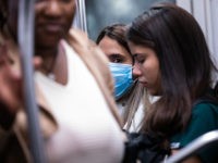 NEW YORK, NY - MARCH 09: A woman wearing a protective mask rides a subway on March 9, 2020 in New York City. The university is canceling classes for two days after a faculty member was quarantined for exposure to the novel coronavirus. (Photo by Jeenah Moon/Getty Images)