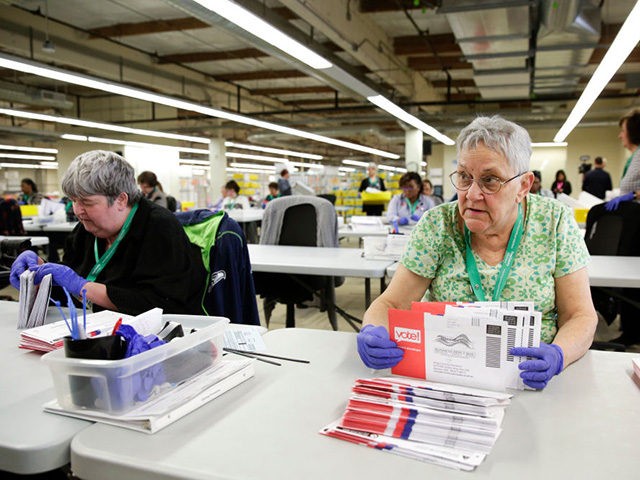 Election worker Ruth Ard opens vote-by-mail ballots for the presidential primary at King County Elections in Renton, Washington on March 10, 2020. (Photo by Jason Redmond / AFP) (Photo by JASON REDMOND/AFP via Getty Images)
