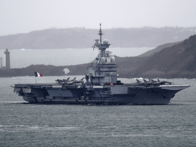 A picture taken on March 13, 2020, shows the French aircraft carrier Charles de Gaulle as it enters the port of Brest, in western France. - The aircraft carrier Charles de Gaulle arrives in Brest on March 13, 2020, as part of a mission in the Atlantic and the North …