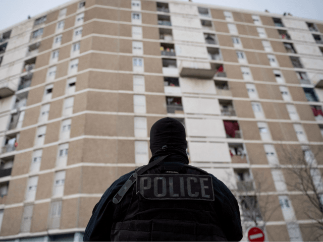 A police officer takes part in an anti-drug operation in the "Cite des Oliviers, a northern neighbourhood of Marseille, southern France on March 25, 2020, as the country is under lockdown to stop the spread of the Covid-19 disease caused by the novel coronavirus. (Photo by CLEMENT MAHOUDEAU / AFP) …