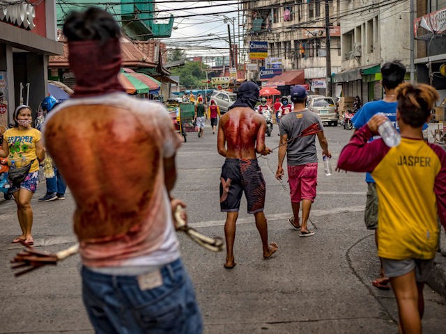 MANILA, PHILIPPINES - APRIL 10: Barefoot flagellants whip their bloodied backs along a street as penance, defying government orders to avoid religious gatherings and stay home to curb the spread of the coronavirus, as they commemorate Good Friday on April 10, 2020 in Manila, Philippines. Good Friday is a Christian holiday commemorating the crucifixion of Jesus and his death at Calvary. It is observed during Holy Week on the Friday preceding Easter Sunday. Most Easter celebrations in the Philippines have been cancelled after religious gatherings have been banned as part of government lockdown measures imposed on the country's main island Luzon to curb the spread of the coronavirus. Land, sea, and air travel has been suspended, while government work, schools, businesses, and public transportation have been ordered shut in a bid to keep some 55 million people at home. The Philippines' Department of Health has so far confirmed 4,076 cases of the new coronavirus in the country, with at least 203 recorded fatalities. The Philippines is the only Roman Catholic majority in Southeast Asia with around 85% practicing the faith. (Photo by Ezra Acayan/Getty Images)