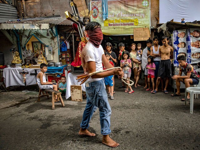 MANILA, PHILIPPINES - APRIL 10: A barefoot flagellant whips his bloodied back along a street as penance, defying government orders to avoid religious gatherings and stay home to curb the spread of the coronavirus, as he commemorates Good Friday on April 10, 2020 in Manila, Philippines. Good Friday is a Christian holiday commemorating the crucifixion of Jesus and his death at Calvary. It is observed during Holy Week on the Friday preceding Easter Sunday. Most Easter celebrations in the Philippines have been cancelled after religious gatherings have been banned as part of government lockdown measures imposed on the country's main island Luzon to curb the spread of the coronavirus. Land, sea, and air travel has been suspended, while government work, schools, businesses, and public transportation have been ordered shut in a bid to keep some 55 million people at home. The Philippines' Department of Health has so far confirmed 4,076 cases of the new coronavirus in the country, with at least 203 recorded fatalities. The Philippines is the only Roman Catholic majority in Southeast Asia with around 85% practicing the faith. (Photo by Ezra Acayan/Getty Images)