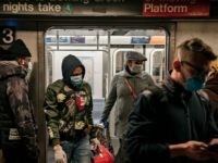NEW YORK, NY - APRIL 17: Commuters wear face masks as they exit a subway train on April 17, 2020 in New York City. Following a new order from Governor Andrew Cuomo (D-NY) that New Yorkers must wear face coverings whenever social distancing is not possible, the measure is the …