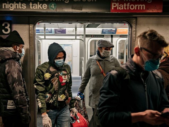 NEW YORK, NY - APRIL 17: Commuters wear face masks as they exit a subway train on April 17, 2020 in New York City. Following a new order from Governor Andrew Cuomo (D-NY) that New Yorkers must wear face coverings whenever social distancing is not possible, the measure is the …