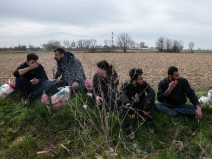 EDIRNE, TURKEY - MARCH 09: Refugees and migrants wait in field near the Pazarkule Border C