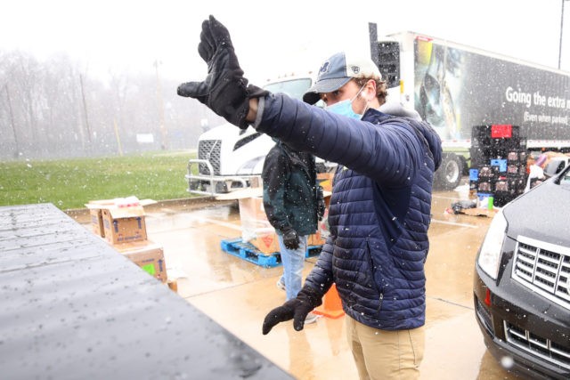 OAK PARK, MICHIGAN - APRIL 15: Sean Furtol of Beverly Hills and a Forgotten Harvest volunteer waves after loading eggs into a car on April 15, 2020 in Detroit, Michigan. The organization distributes food throughout the metro area, which has seen an uptick in demand due to the COVID-19 pandemic. …