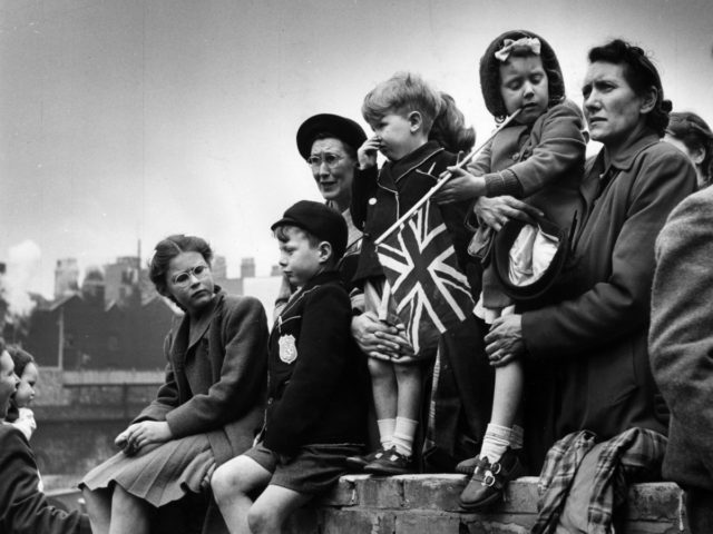 19th May 1951: Families watching the Royal procession as King George VI goes to St Paul's to declare the Festival of Britain open. Original Publication: Picture Post - 5306 - The Royal Opening To Britain's Festival - pub. 1951 (Photo by Picture Post/Hulton Archive/Getty Images)